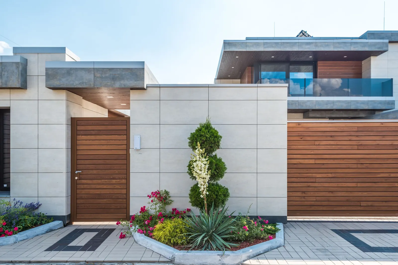 Nieuw aangelegde tuin met pad en gazon naast een woning